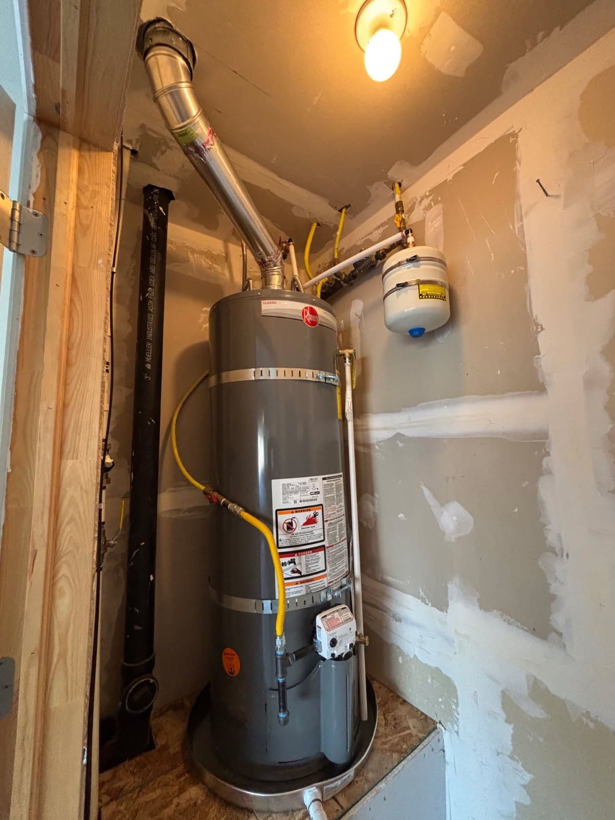 Gallery photos for Efficient Water Heater Installation with Added Floor Protection: Image #1